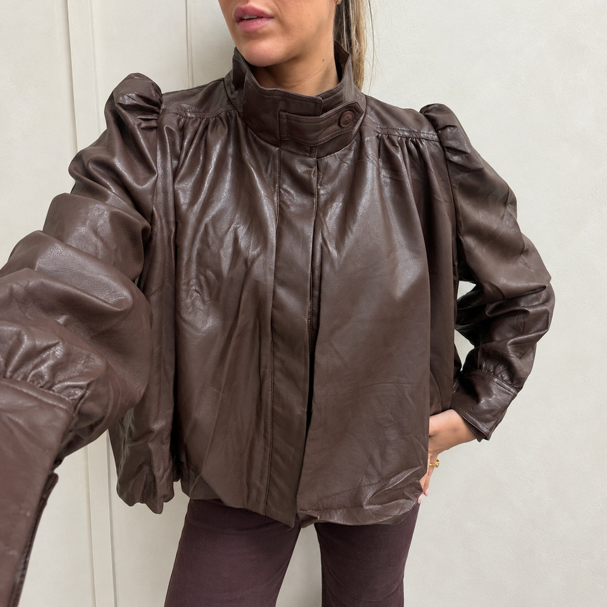 Chocolate brown faux leather puff shoulder jacket with high collar, cropped below the nose